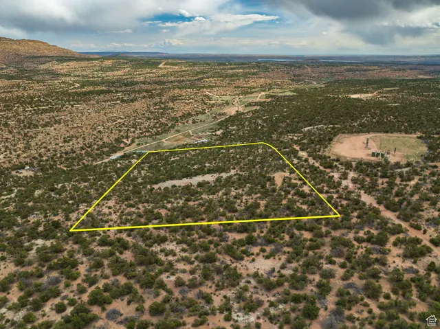 Aerial view of sparsely populated area with property parcel outlined
