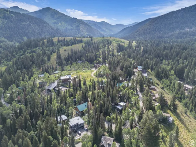 Aerial view of property and surrounding area with a mountainous background