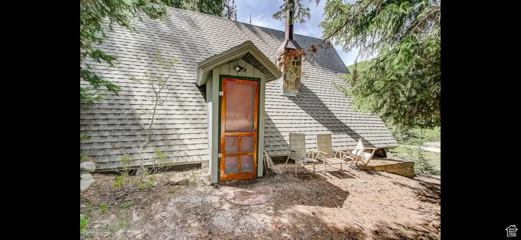 View of front of house featuring a shingled roof