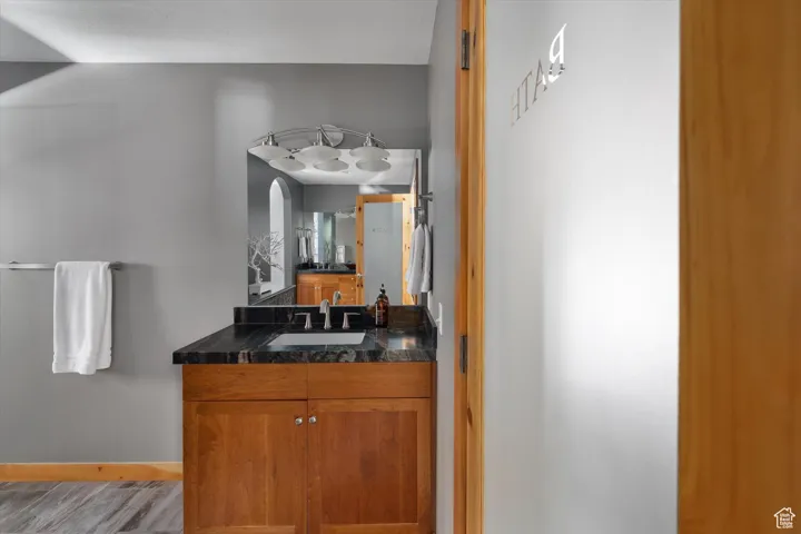 Bathroom with vanity and wood finished floors