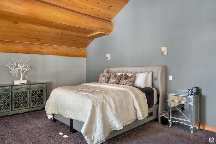 Bedroom featuring carpet and wooden ceiling