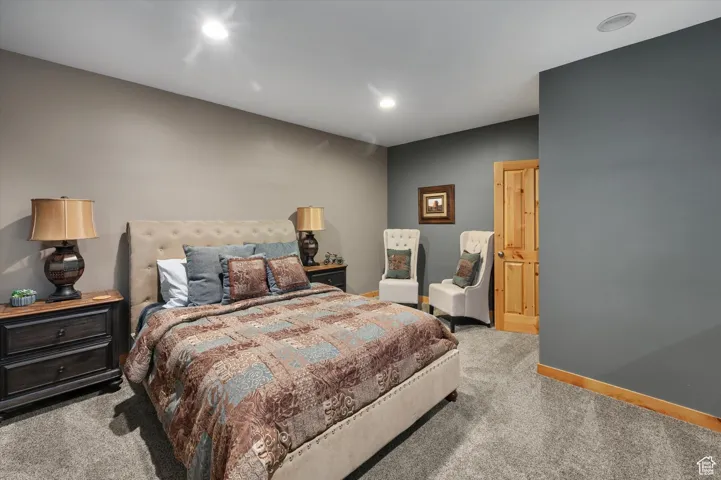 Carpeted bedroom with recessed lighting and baseboards
