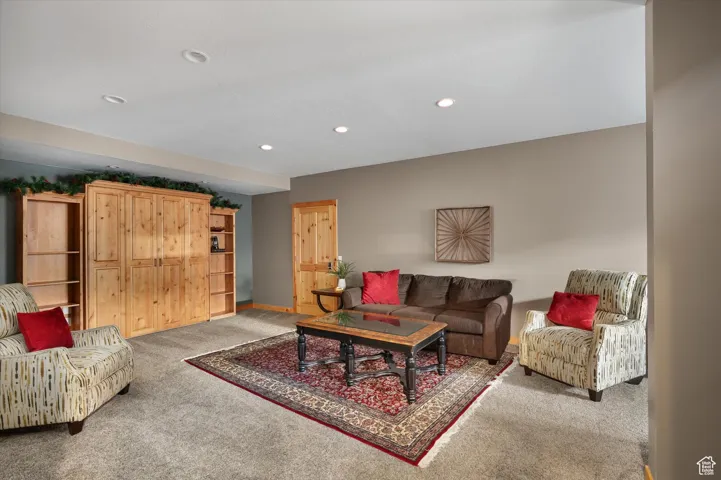 Living area featuring light colored carpet and recessed lighting
