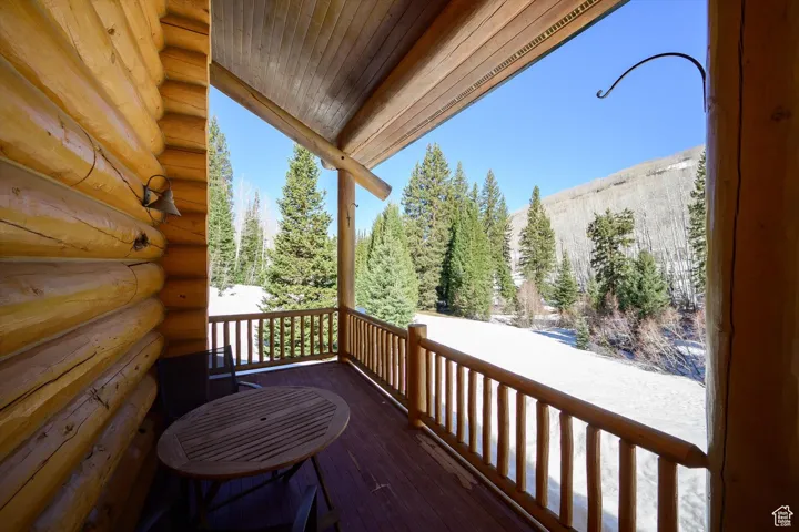 Wooden deck featuring a forest view