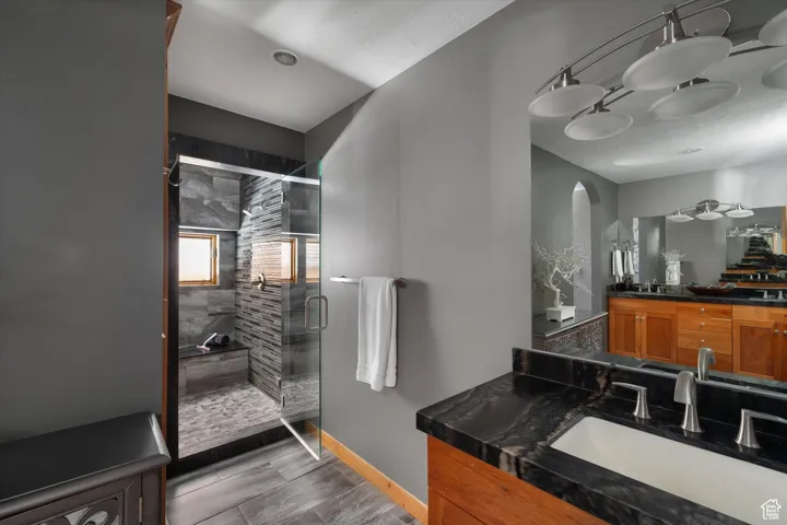 Bathroom featuring a shower stall and vanity
