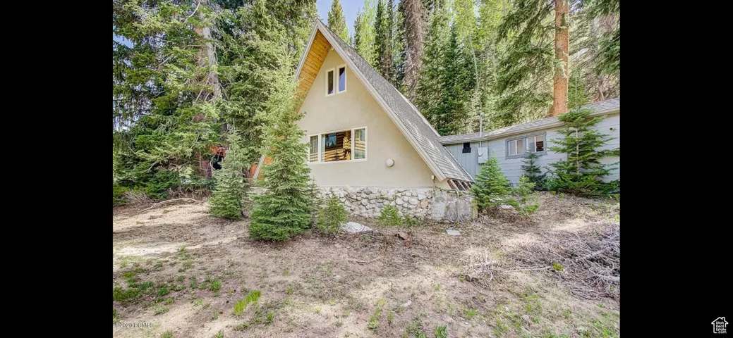 View of side of home with stucco siding and stone siding