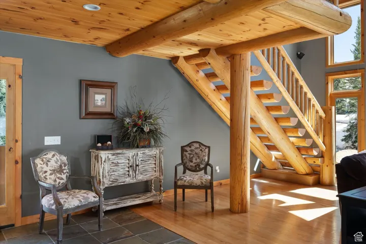 Sitting room featuring stairway, a wood ceiling with exposed beams, and recessed lighting