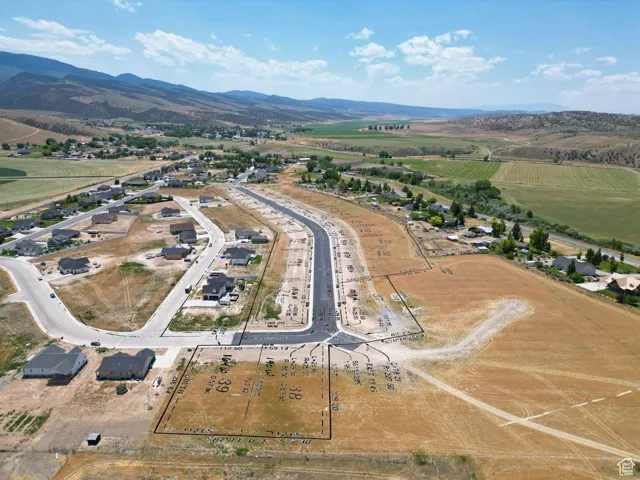 Aerial view of property's location with mountains and rural landscape
