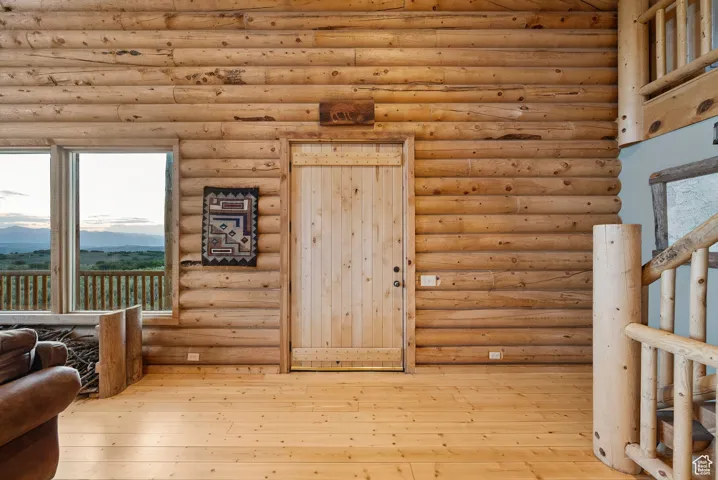 Sitting room featuring rustic walls, hardwood / wood-style flooring, and a mountain view
