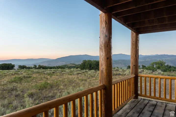 Deck at dusk featuring a mountain view