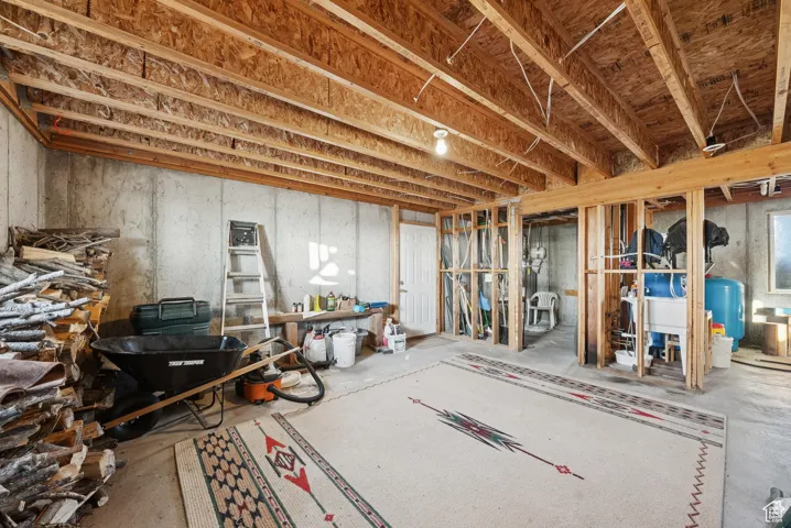Unfinished basement featuring a water pressure tank