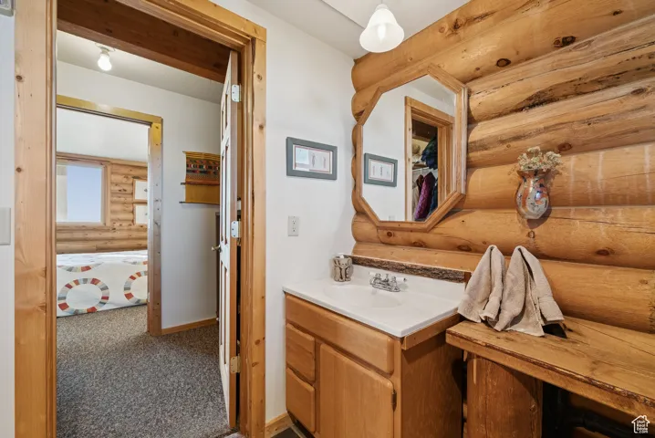 Bathroom with log walls and vanity