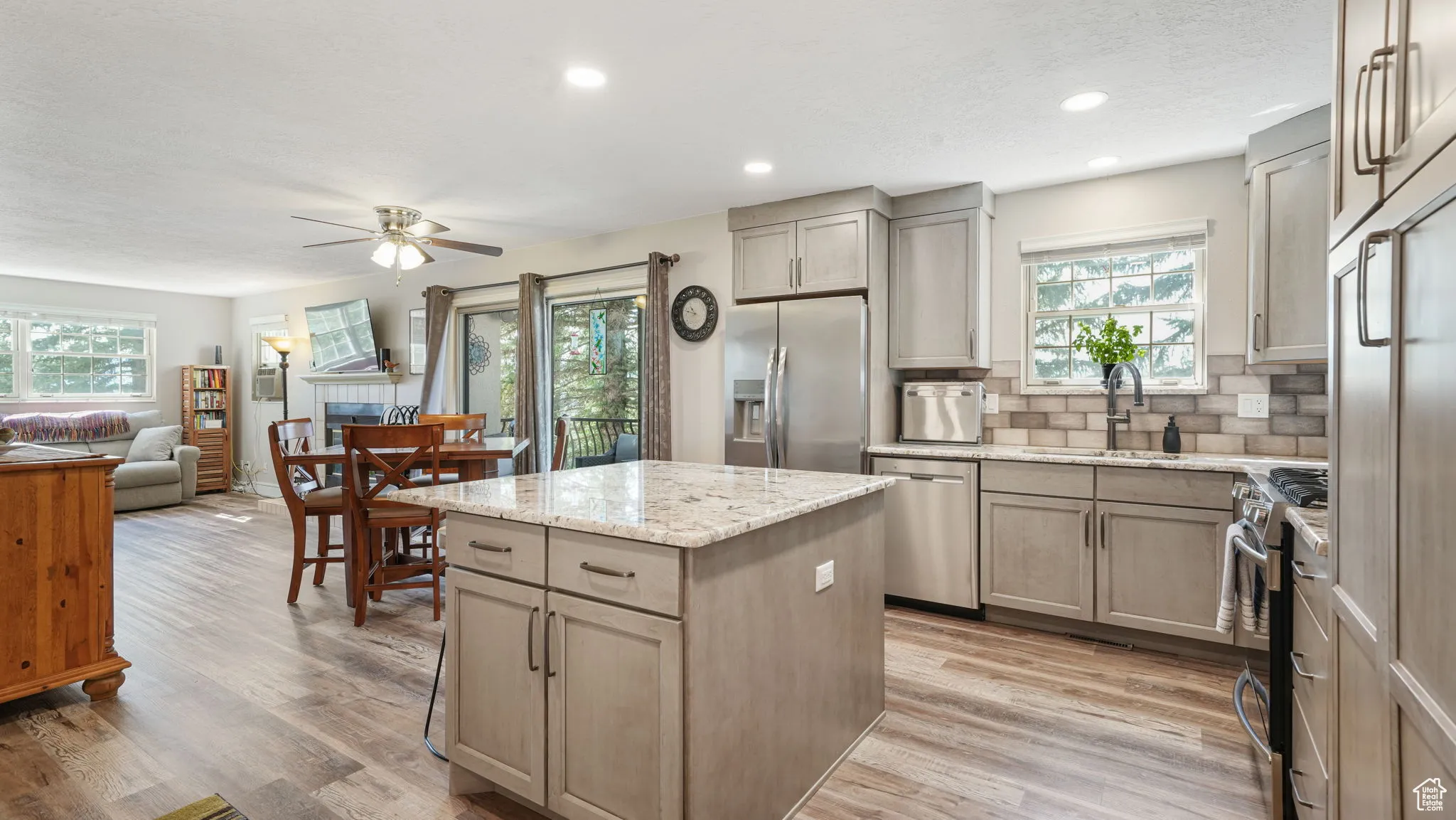 Kitchen featuring appliances with stainless steel finishes, healthy amount of natural light, a ceiling fan, a kitchen island, and recessed lighting