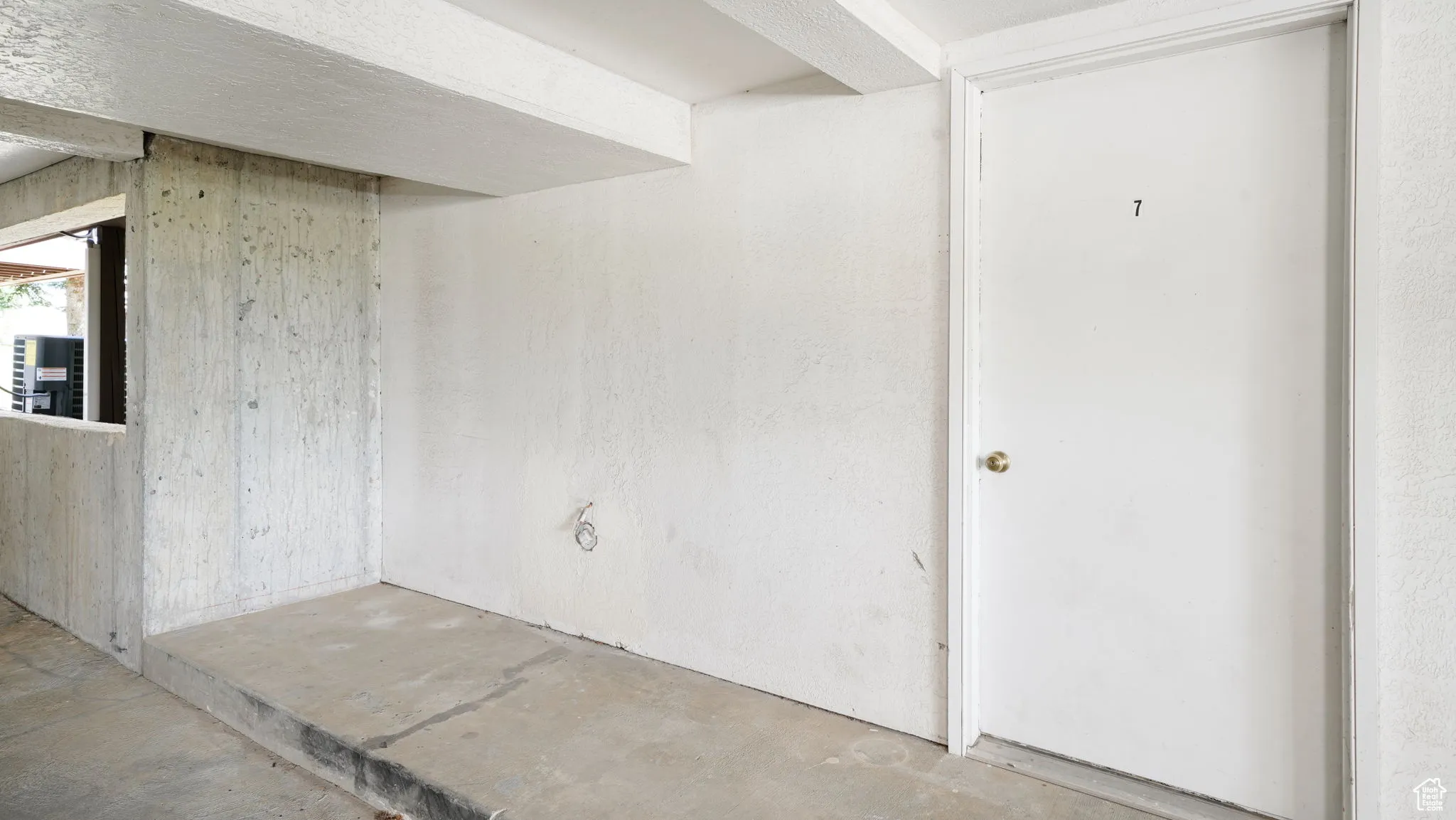 Unfurnished room with unfinished concrete floors