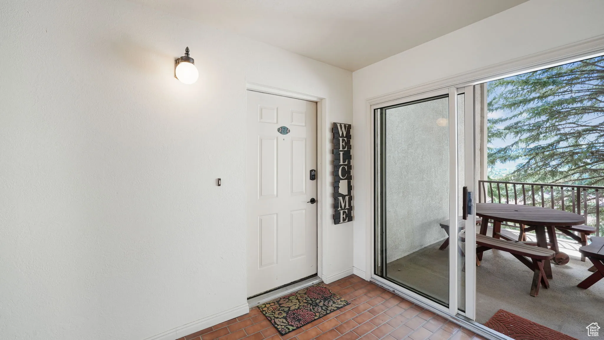 Property entrance featuring a balcony