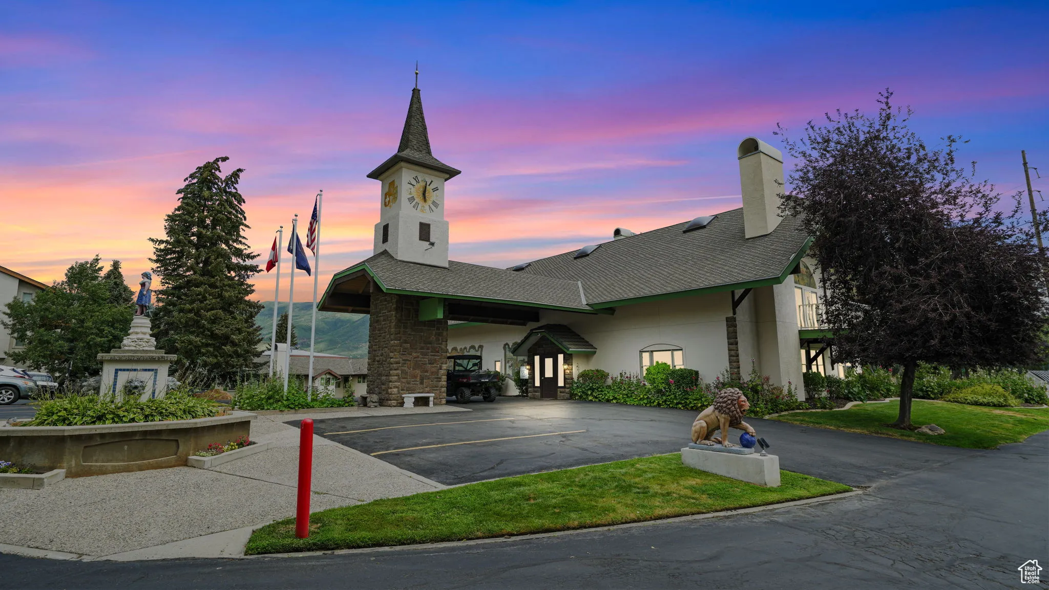 Property at dusk featuring uncovered parking
