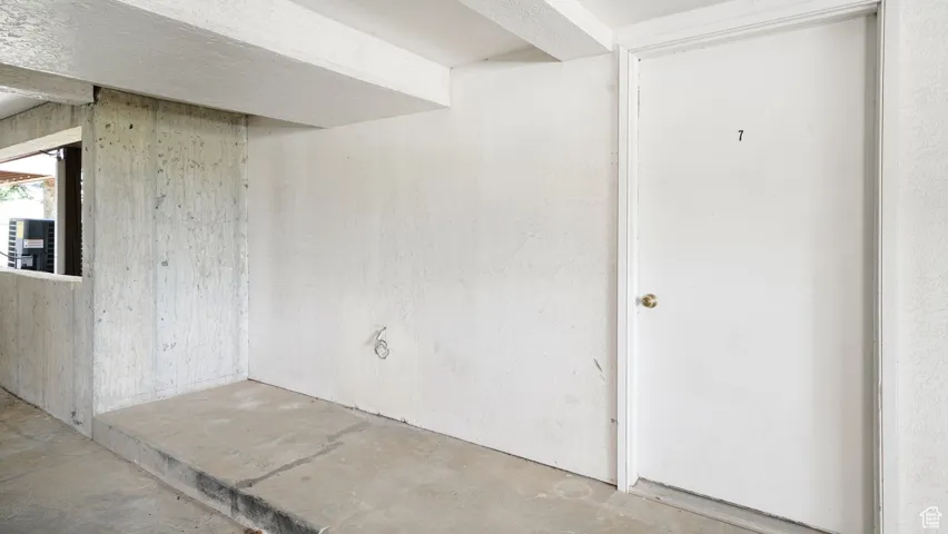 Unfurnished room with unfinished concrete floors