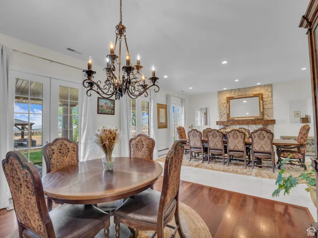 Dining space with french doors, healthy amount of natural ligh floors, and recessed lighting