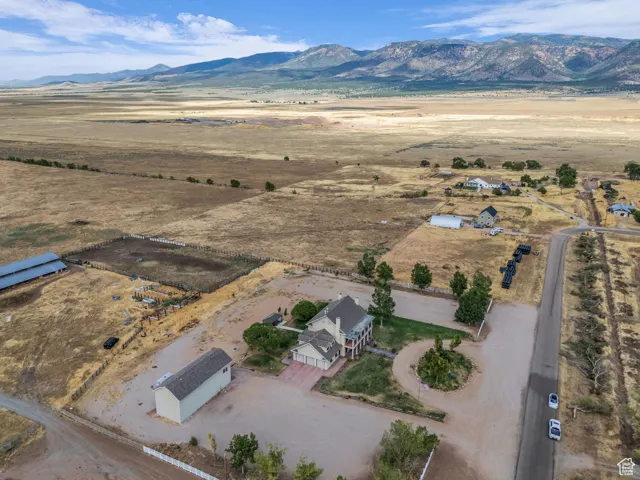 Aerial view of property's location featuring rural landscape and a mountainous background