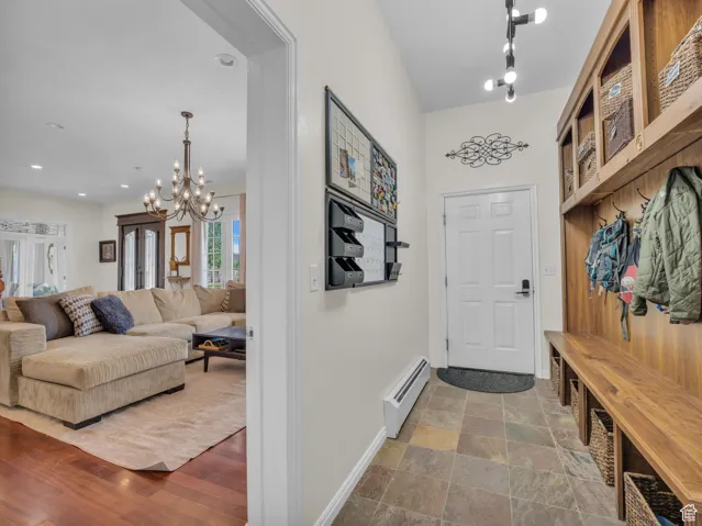 Mudroom featuring a chandelier and baseboard heating