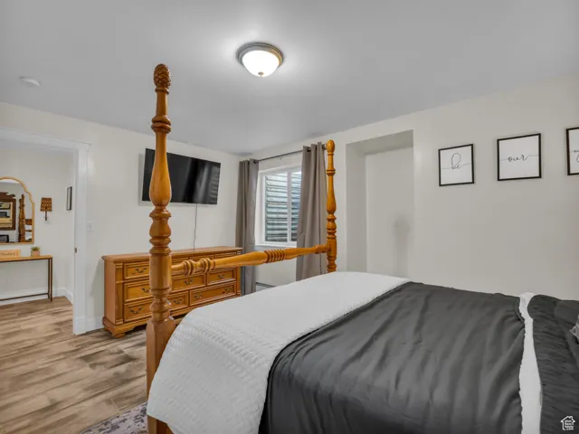 Bedroom with light wood-style flooring and baseboards