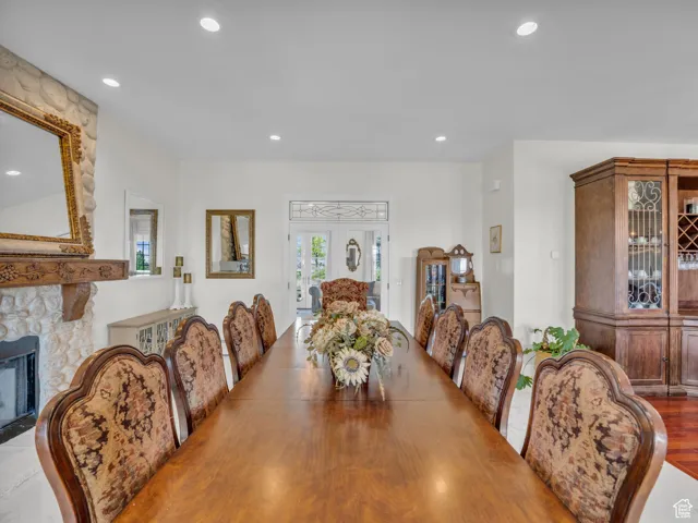 Dining area with recessed lighting and a stone fireplace