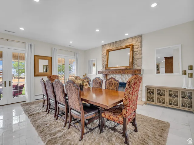 Dining area with french doors, marble flooring, and recessed lighting