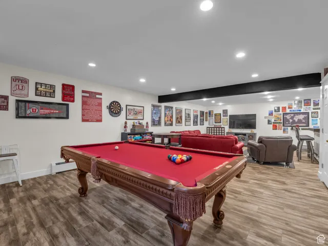 Recreation room featuring recessed lighting, wood finished floors, billiards table, and a baseboard radiator