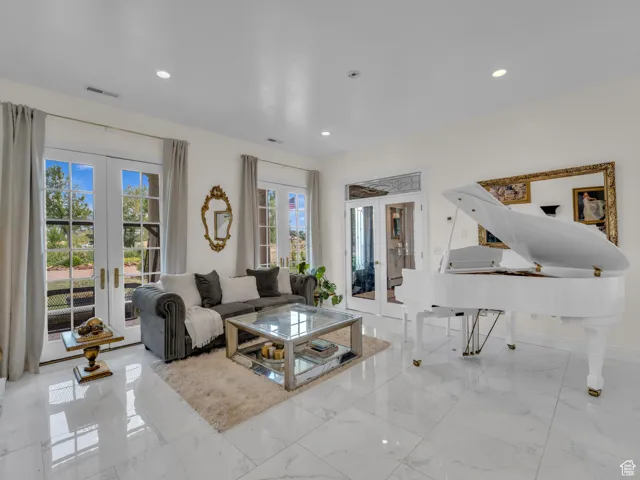 Living area featuring french doors, recessed lighting, and marble floors