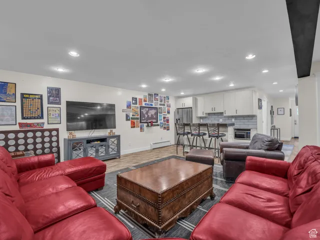 Living room featuring recessed lighting and a baseboard radiator