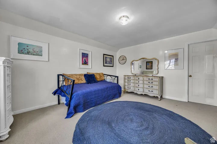 Carpeted bedroom with baseboards located on the upper level of the second floor.
