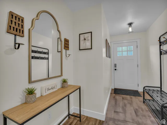 Entrance foyer featuring wood finished floors and baseboards