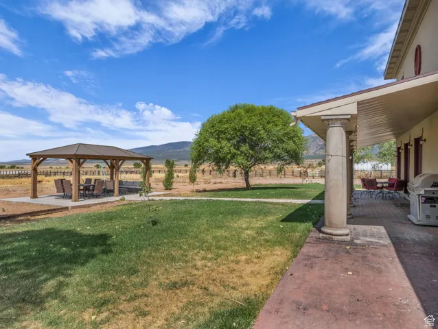 View of yard featuring a gazebo, a patio, and a mountain view