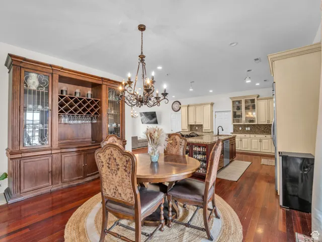 Dining space with a chandelier, recessed lighting, and hardwood floors