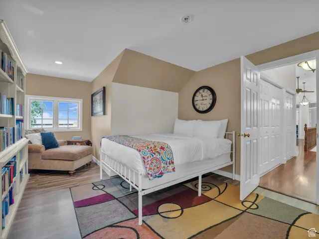 Bedroom with wood finished floors and recessed lighting