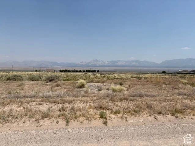 View of mountain backdrop featuring rural landscape