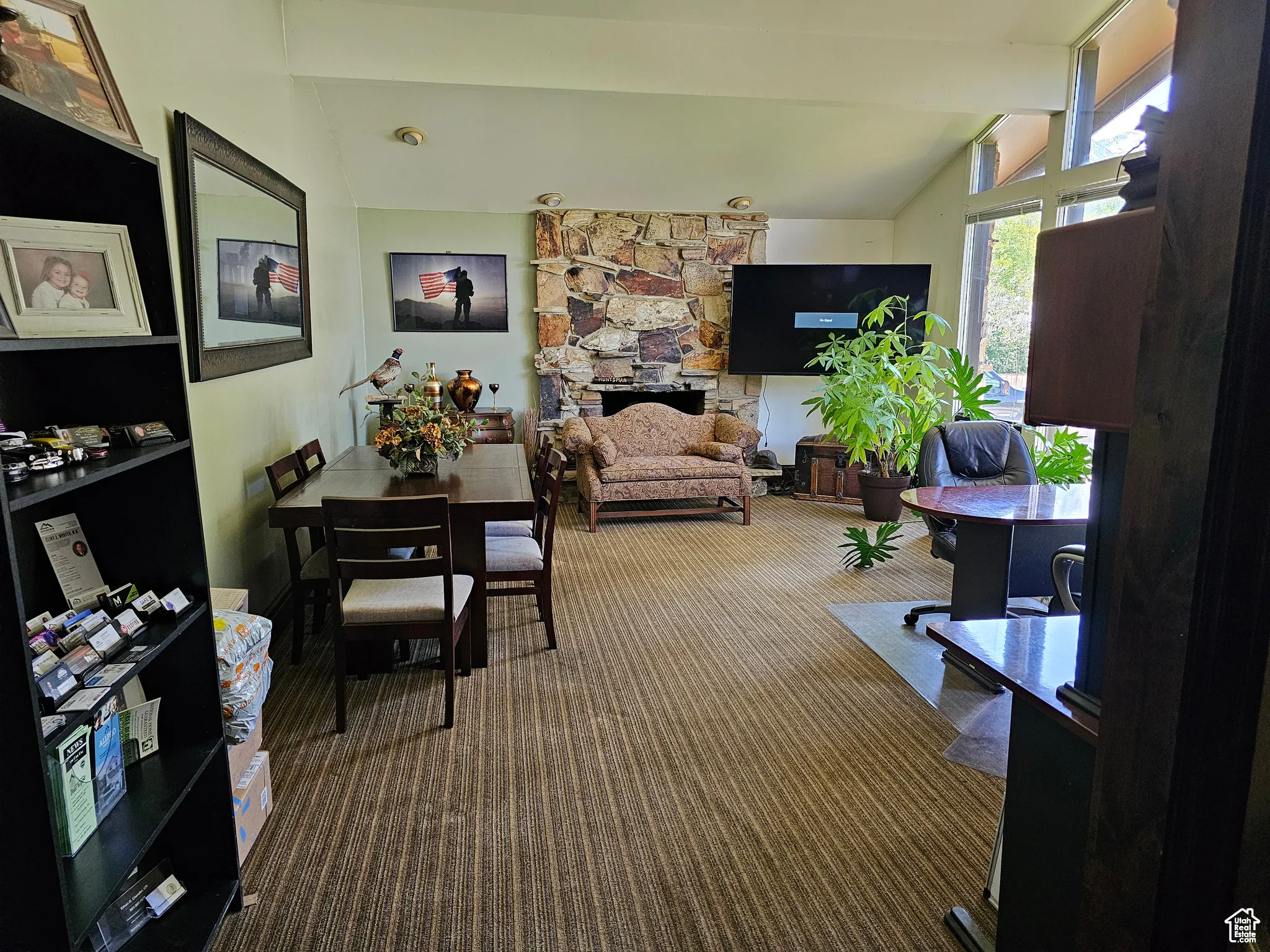 Office space with carpet and a stone fireplace