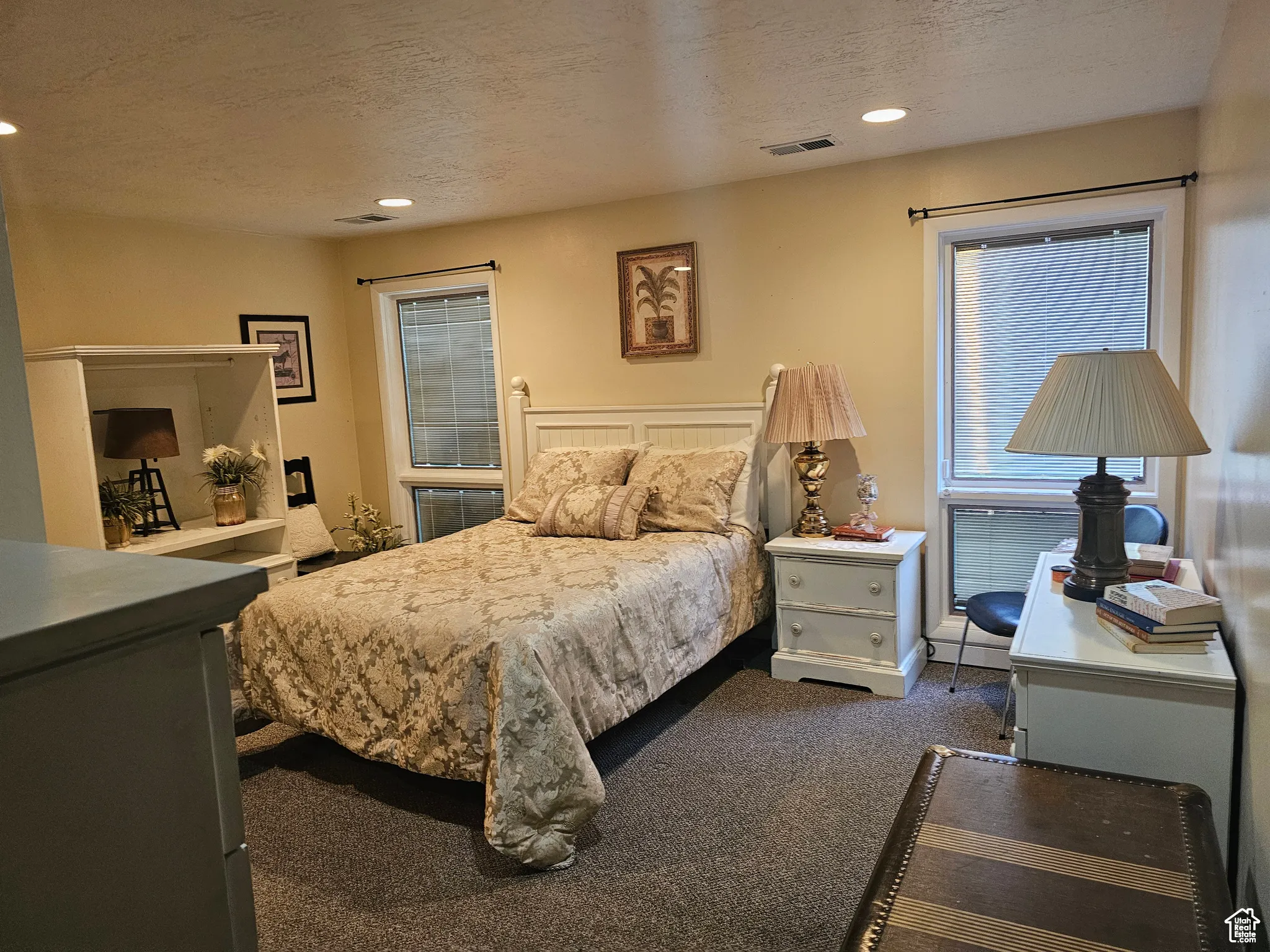 Bedroom featuring a textured ceiling, dark carpet, and recessed lighting
