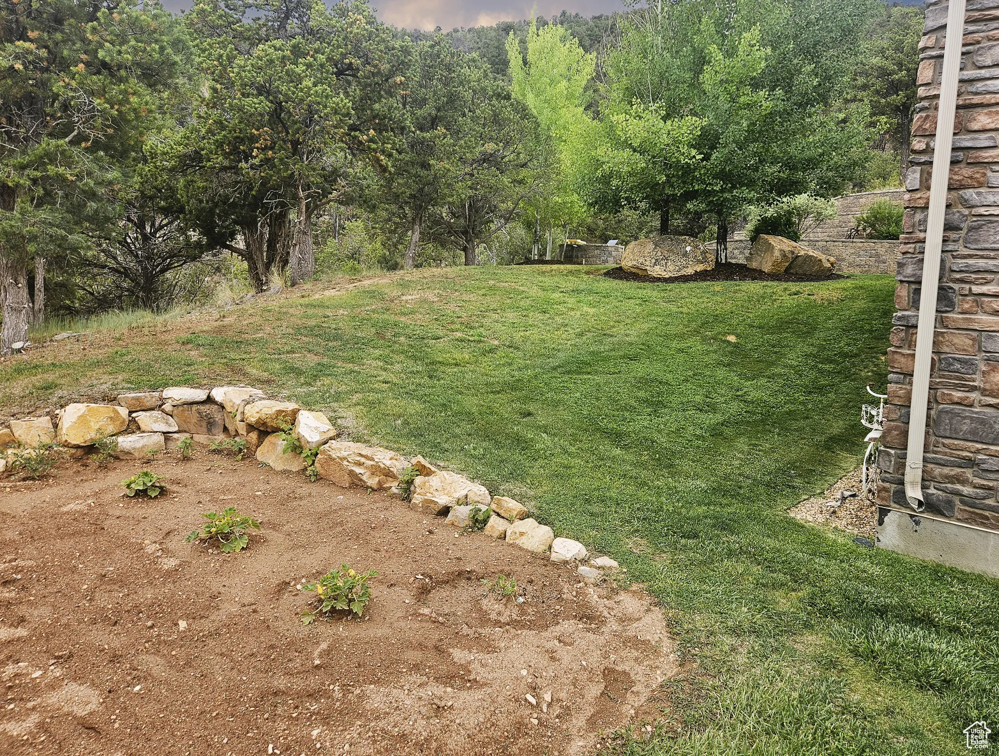 Surrounded by mountain views, the rambling yard offers a perfect blend of manicured and wild—ideal for entertaining, gardening, or simply enjoying the serenity of the land.