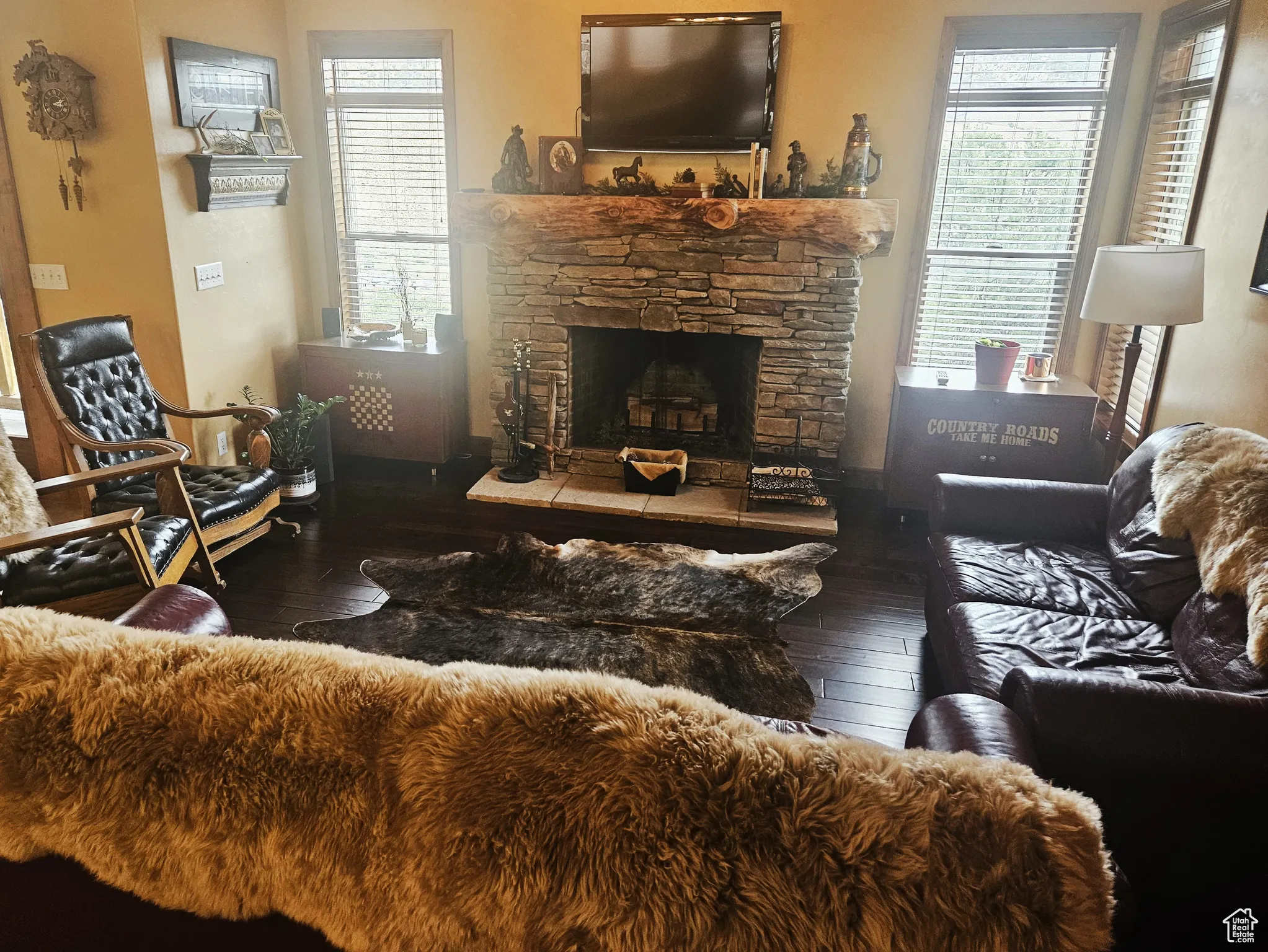 A roaring fireplace anchors the great room, offering a cozy retreat with plenty of natural light and mountain views.