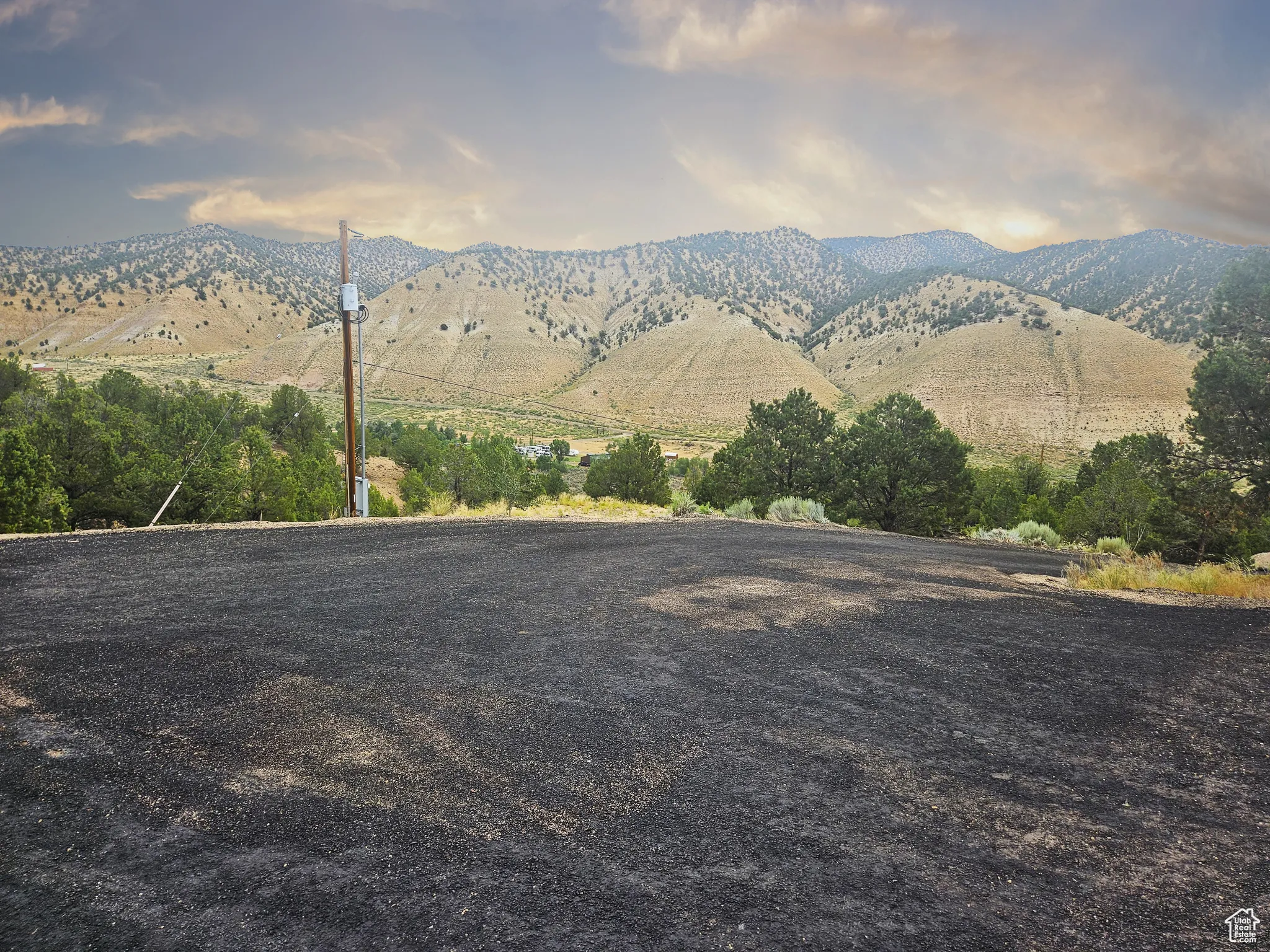 A peaceful approach—lined with natural landscape and big western skies—sets the tone for the breathtaking scenery that surrounds this home.