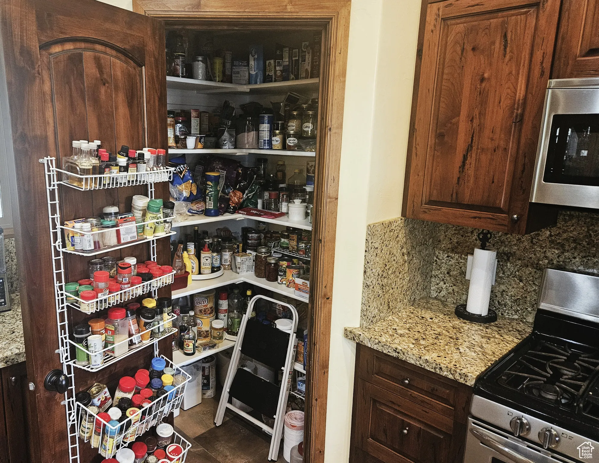 Maximize your kitchen’s efficiency with this spacious corner reach-in pantry, perfectly positioned for seamless meal prep.