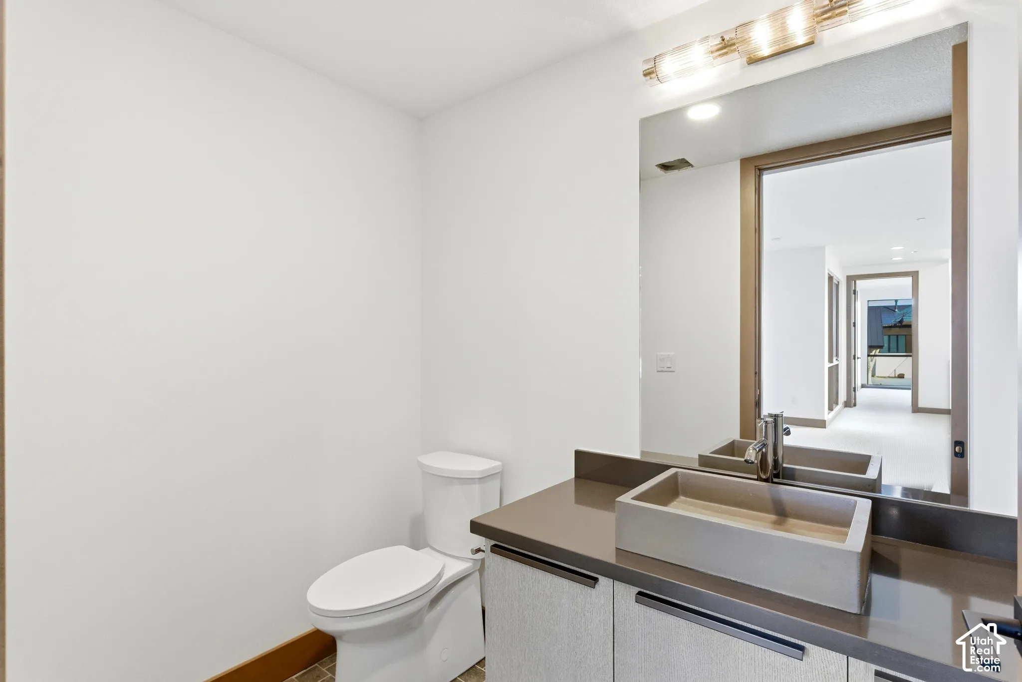 Half bath featuring toilet and vanity