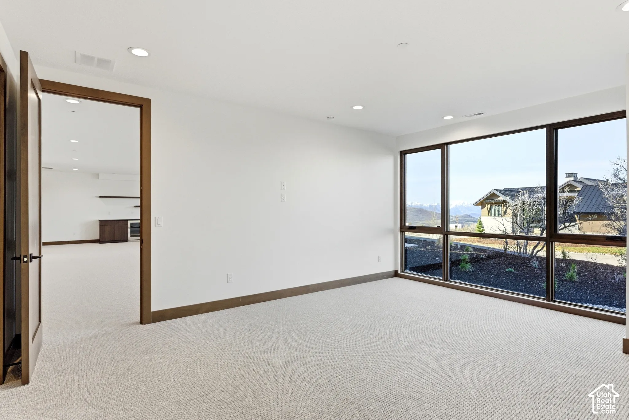 Unfurnished room with light carpet and recessed lighting