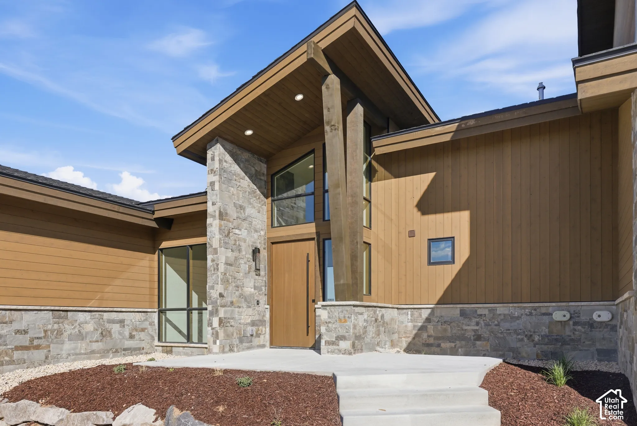 Entrance to property with stone siding