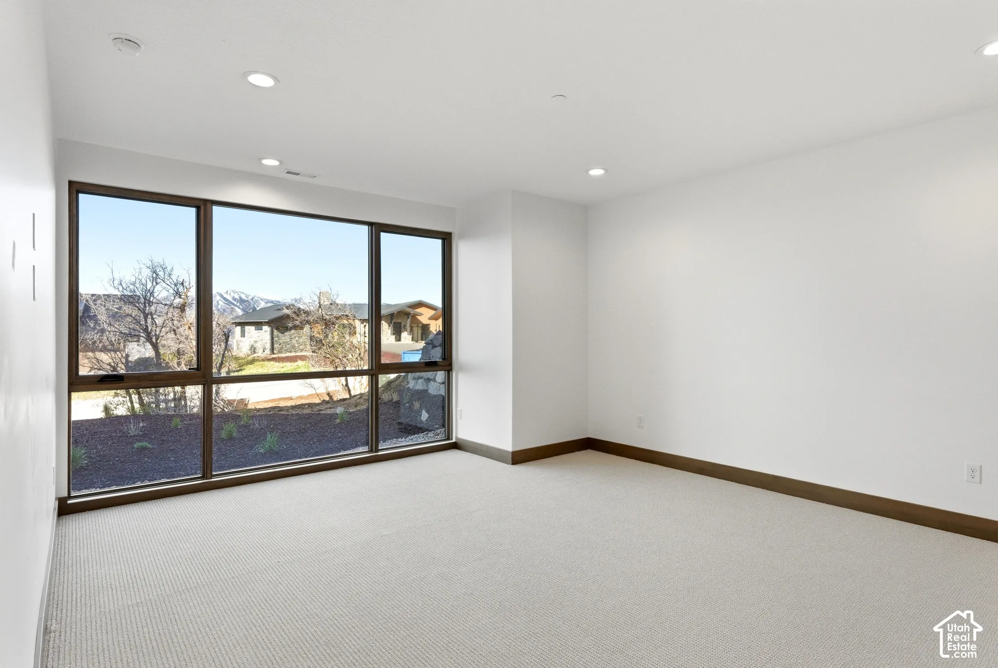 Spare room with light carpet and recessed lighting