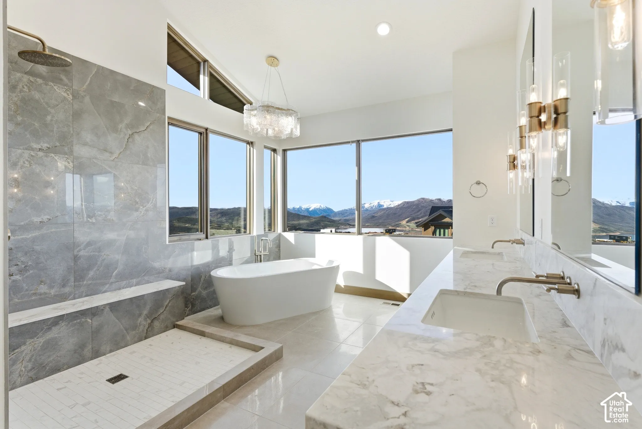 Full bath featuring a mountain view, double vanity, a freestanding tub, a marble finish shower, and recessed lighting