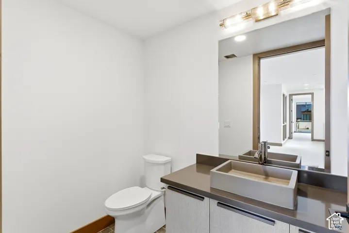 Half bath featuring toilet and vanity