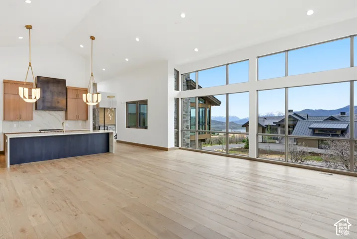 Expansive living area with high ceilings and wood-finish flooring