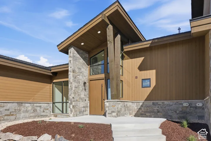 Entrance to property with stone siding